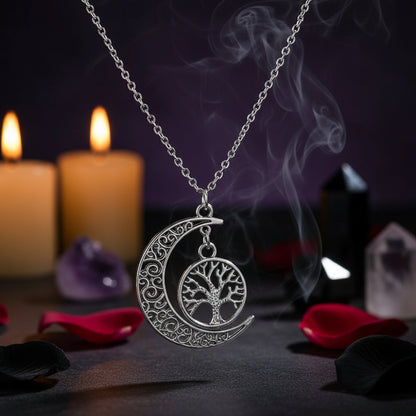 Silver crescent moon and tree of life pendant on a chain against a white background