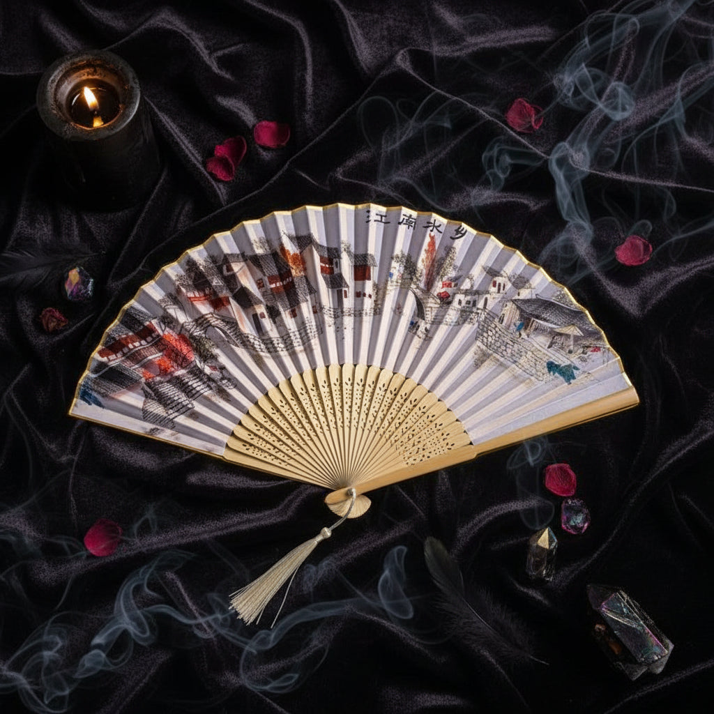 Handheld fan with scenic design on a white background with pink flowers