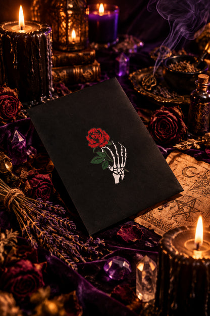 Black square with a skeleton hand holding a red rose on a white background