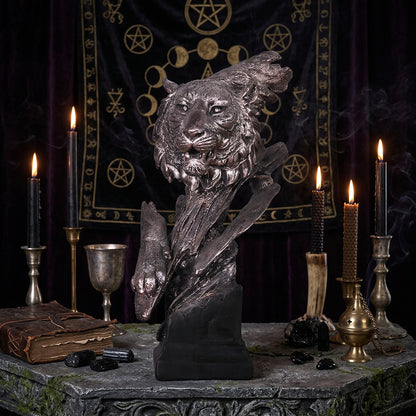 Bronze sculpture of a wolf on a wooden surface with a blurred background