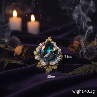 Decorative brooch with gemstones and measurements on a white background