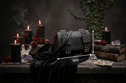 Black studded handbag with measurements on a white surface