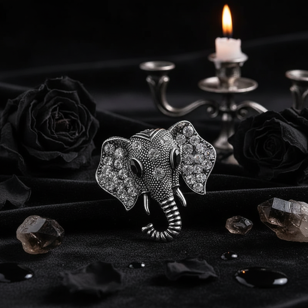 Silver elephant brooch with rhinestones on a gray surface