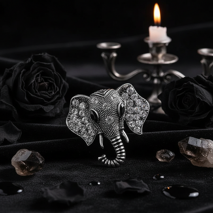 Silver elephant brooch with rhinestones on a gray surface