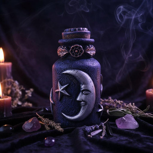 Decorative jar with moon and star design on a wooden surface