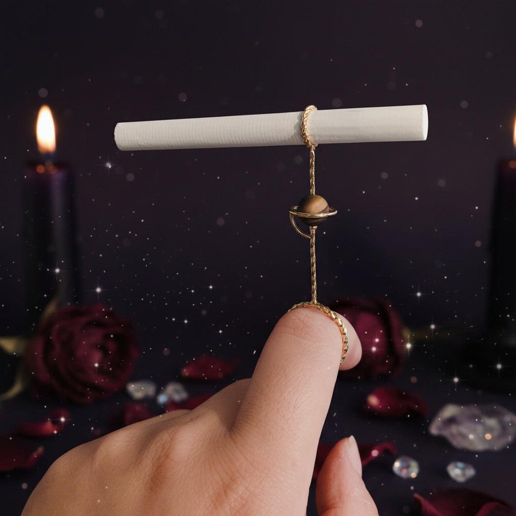 Hand holding a small decorative object with a plain background