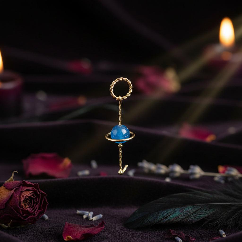 Gold ring with a blue gemstone on a white background