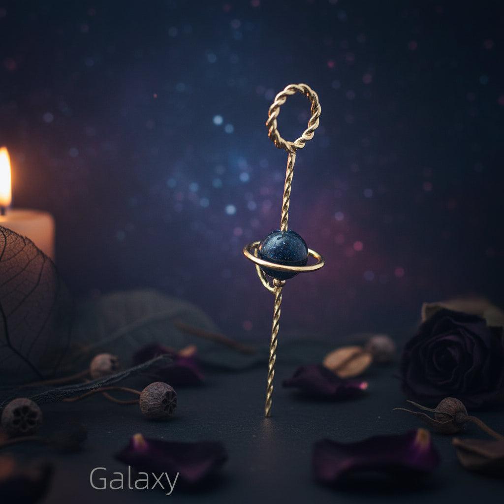 Gold keychain with a blue stone on a white background, labeled 'Galaxy'.