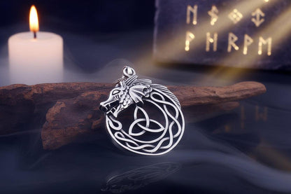 Silver wolf pendant with Celtic knot design on a dark background
