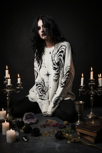 White sweater with black spiral pattern on a white background