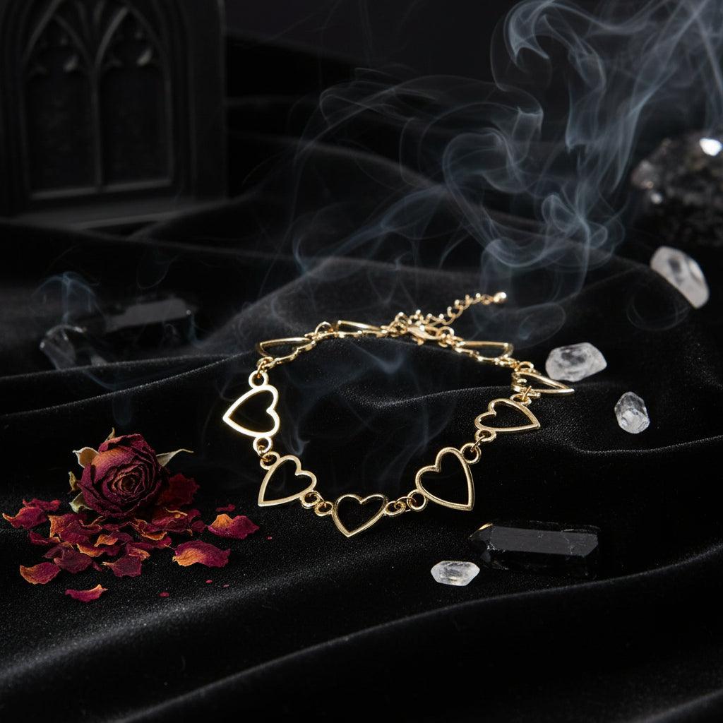 Gold bracelet with heart-shaped links on a white background