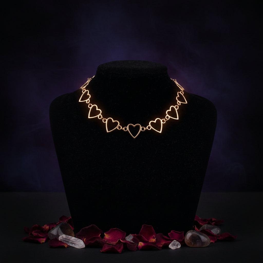Rose gold heart-shaped necklace on a black mannequin against a gray background