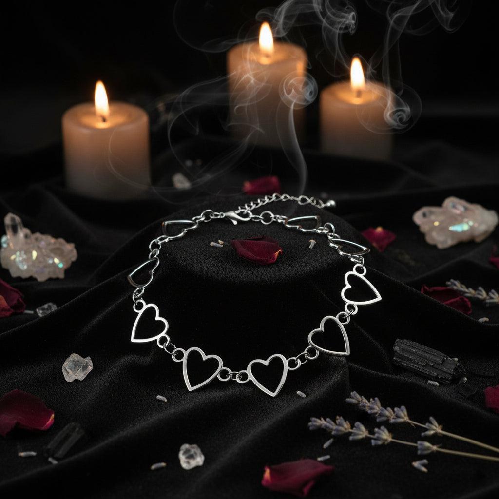 Silver bracelet with heart-shaped links on a white background