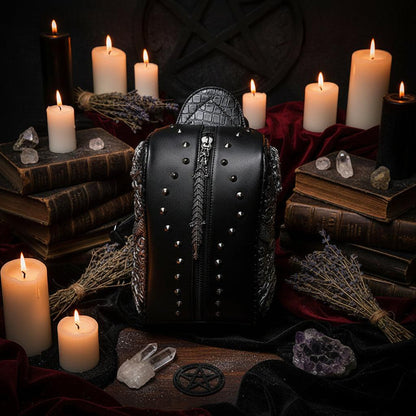 Close-up of a black leather bag with silver studs and intricate detailing.