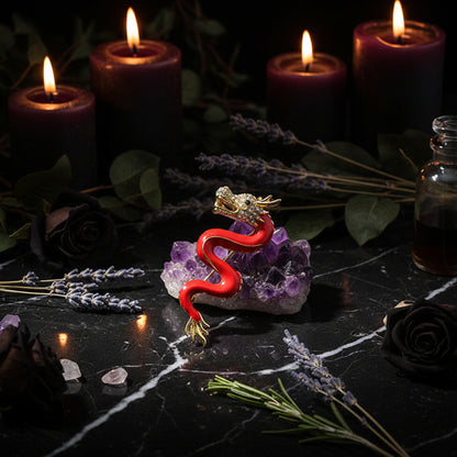 Red and gold dragon brooch on a perfume bottle