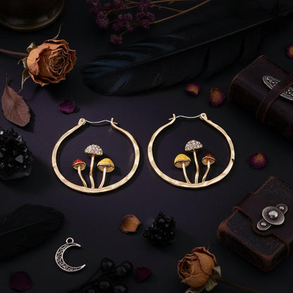 Gold hoop earrings with mushroom designs and measurements on a white background
