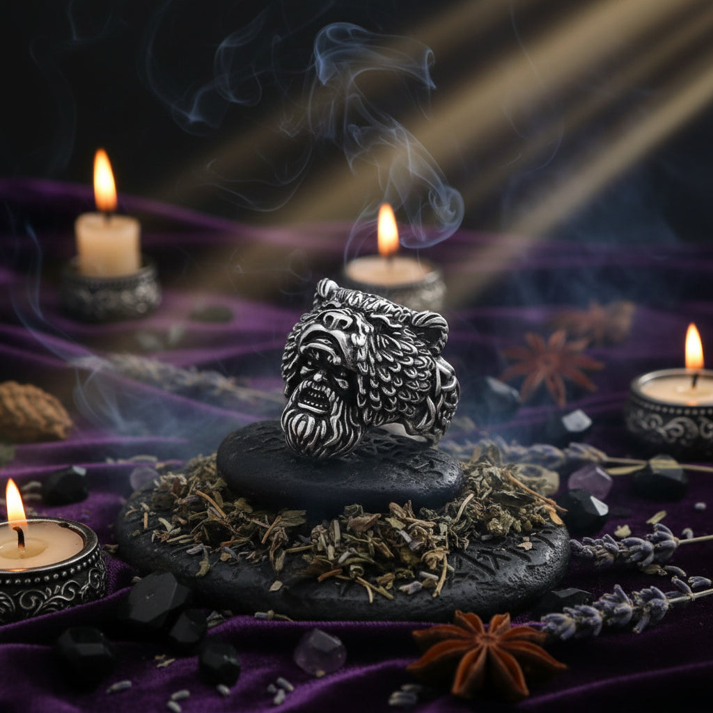 Silver lion head ring on a stone surface with a dark background