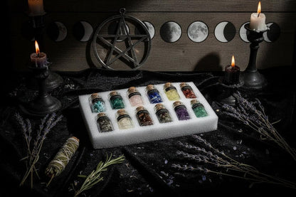 Set of small glass bottles with cork lids containing various crystals, held in a protective foam tray.