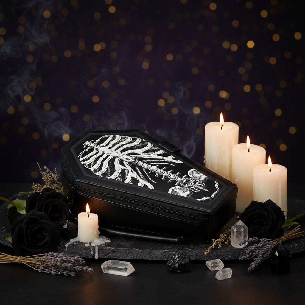 Black coffin-shaped bag with a skeleton design on a white background