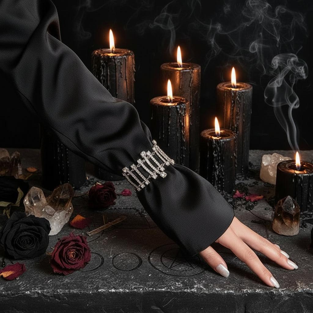 Black sleeve with decorative elements against a neutral background