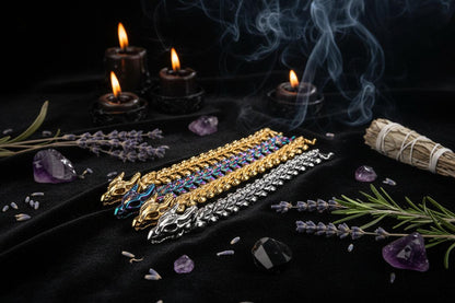 Set of four bracelets in gold, silver, and iridescent colors on a white background