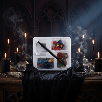Witchcraft supplies including a wand, crystals, and candles on a dark background with smoke.