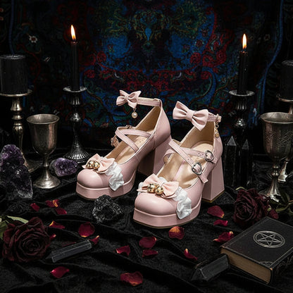 Pink platform shoes with decorative bows and flowers worn with heart-patterned tights on a neutral background.