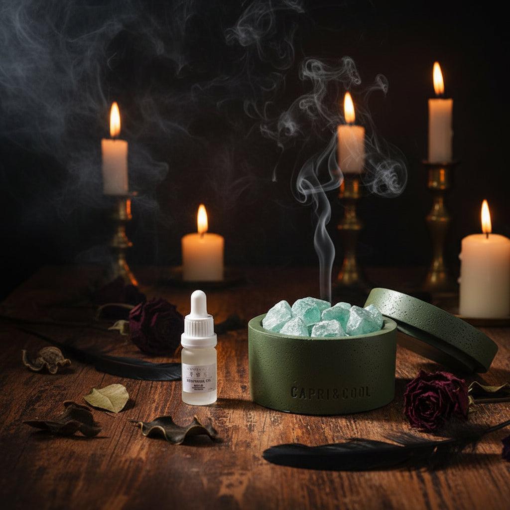 A Caffe Cool skincare gift set featuring a white box, a small dropper bottle, and an olive green textured container filled with green crystals, displayed on a white marble surface.