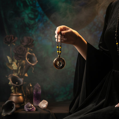 Person holding a necklace with a large pendant