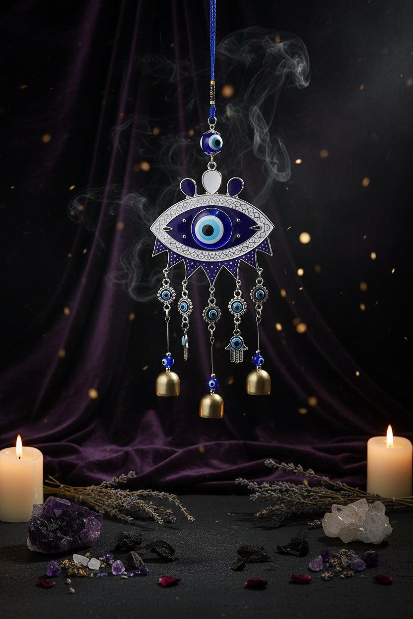 Decorative evil eye hanging with bells against a blue background
