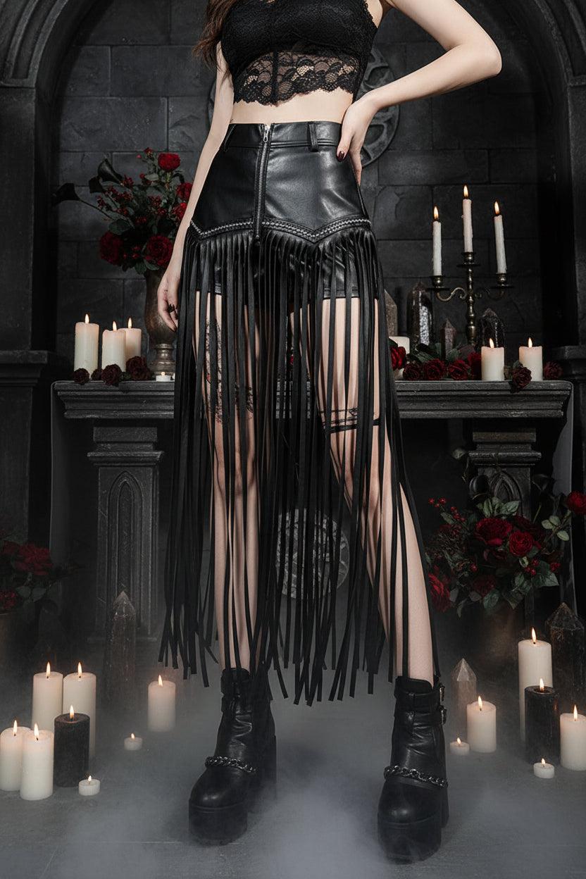 Person wearing a black fringe skirt and high-heeled boots in a room with furniture.