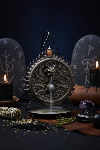 Decorative incense burner with dragon design on a black background