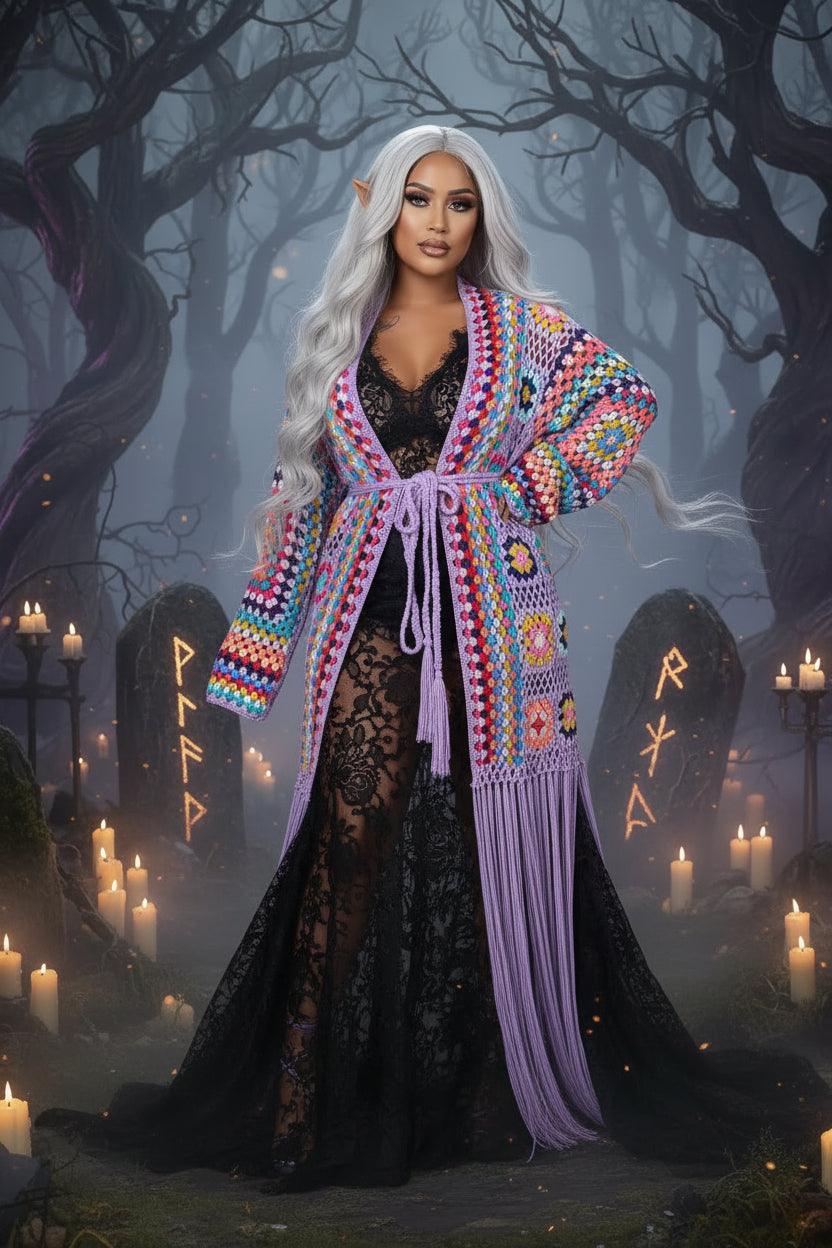 Woman wearing a colorful, patterned kimono with purple fringe on a gray background