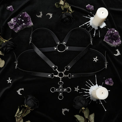 Black leather harness with metal accents on a white background