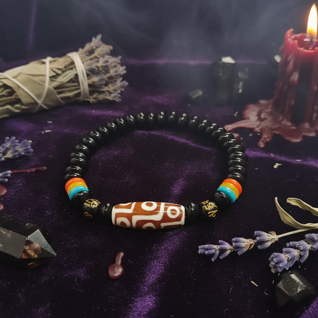 Black beaded bracelet with colorful accents on a hand against a blurred background