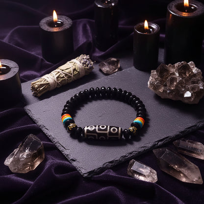 Black beaded bracelet with colorful accents on a hand