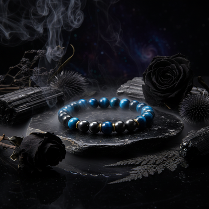 Blue and black beaded bracelet with gold accents on a white background