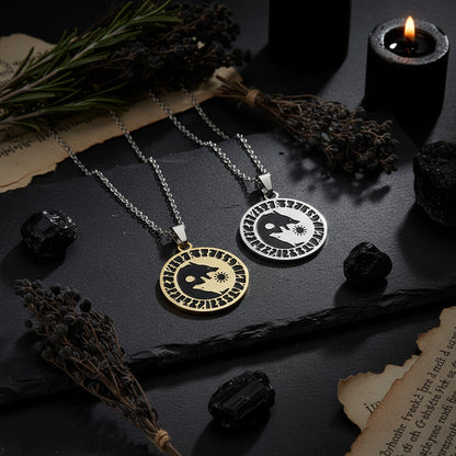 Two necklaces with wolf and moon pendants on a skin and white background