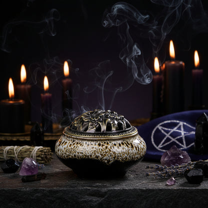 Ceramic incense burner with decorative lid on a wooden surface
