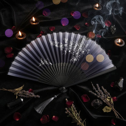 Black folding fan with floral design on a white background with pink flowers