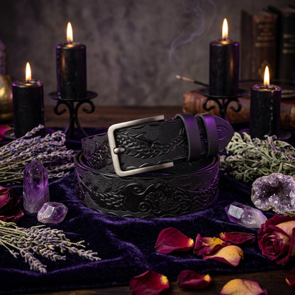 Black leather belt with embossed design and bronze buckle on a white background