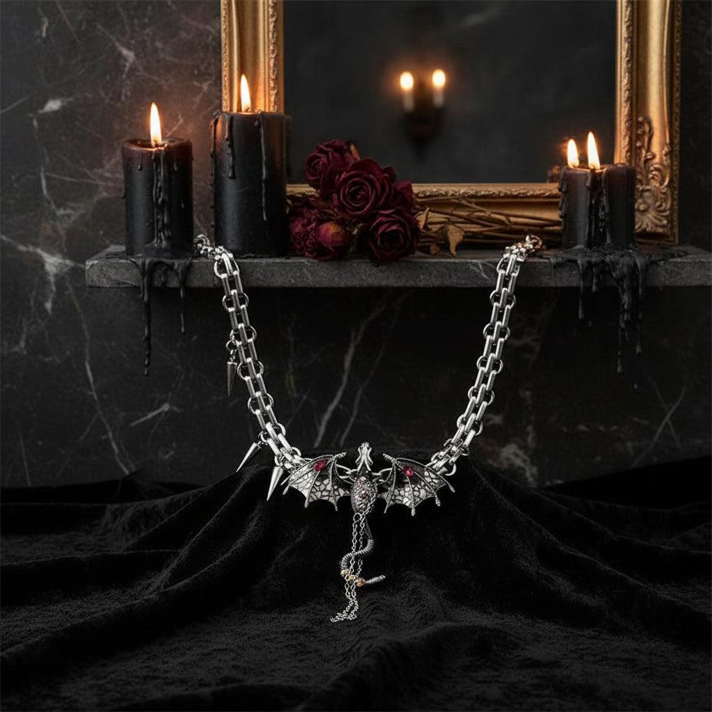 Dragon-shaped pendant on a chain with a cup and saucer in the background