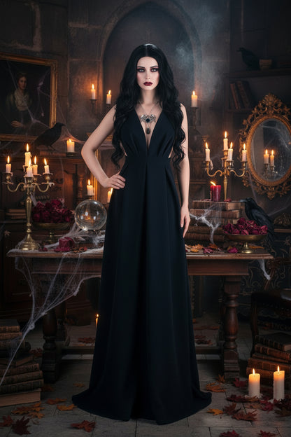 Mannequin wearing a black dress with a deep neckline and a silver necklace with a blue gemstone.
