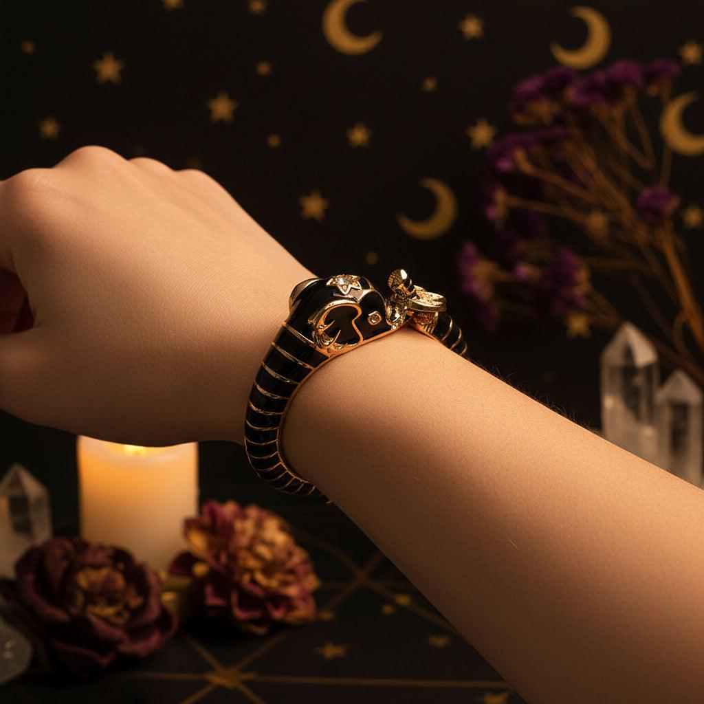 Close-up of a person's wrist wearing a decorative ring with black and gold design.