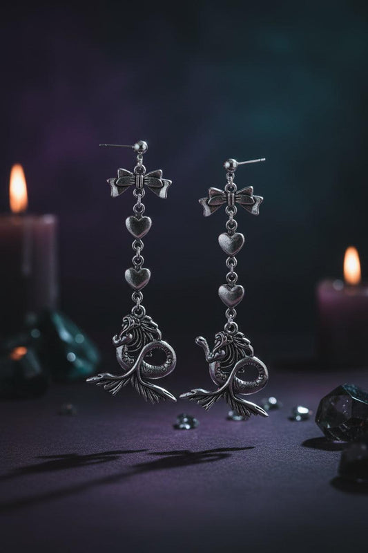 Pair of silver earrings with intricate designs on a white background