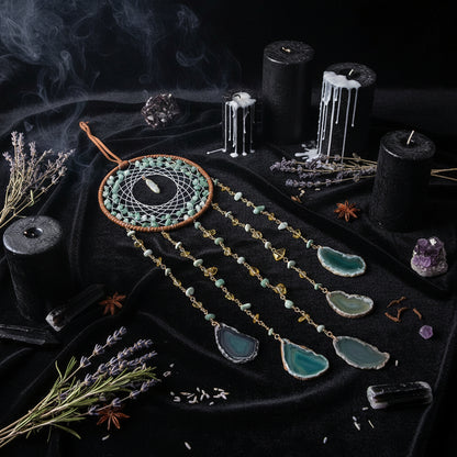 Dreamcatcher with turquoise stones on a wooden surface