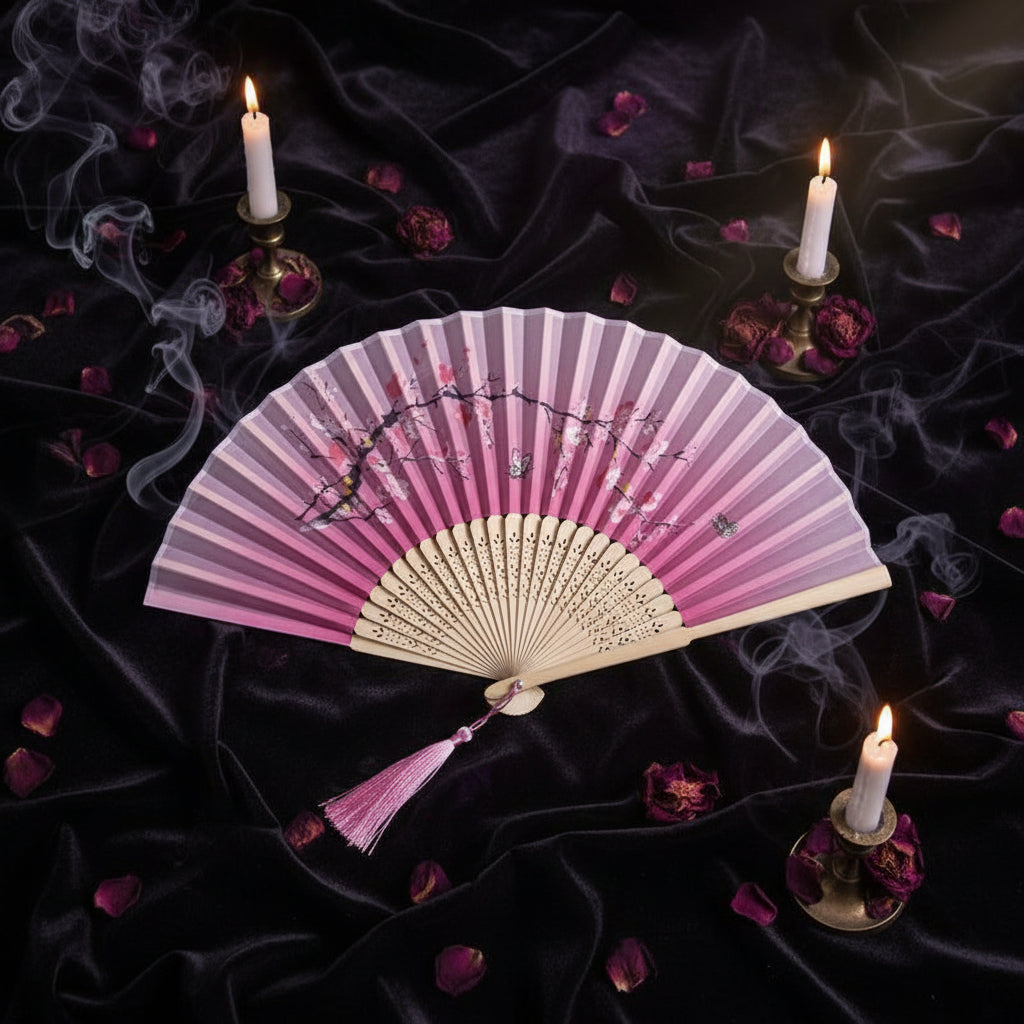 Pink hand fan with cherry blossom design on a light pink background