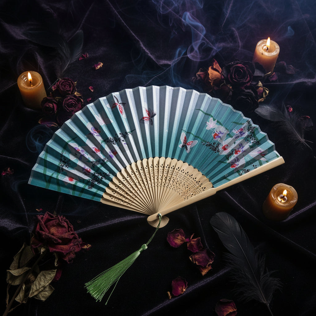 Traditional Chinese folding fan with floral design on a white background with pink flowers.