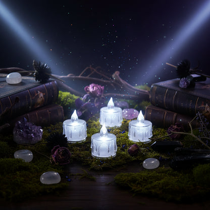 Set of four LED candles on a textured surface with a blurred background