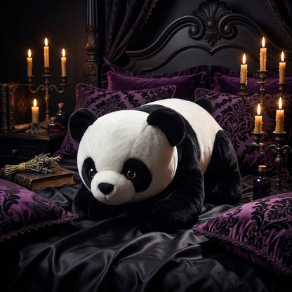 Plush panda toy on a wooden floor with a blurred background